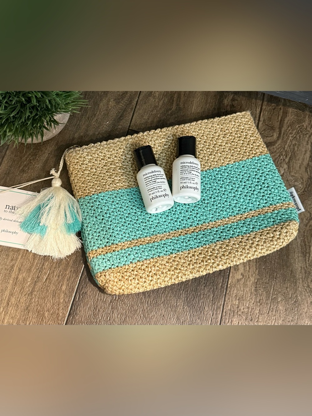 Philosophy skincare duo on turquoise and natural straw clutch